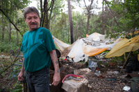 Thomas in past camp in the woods.